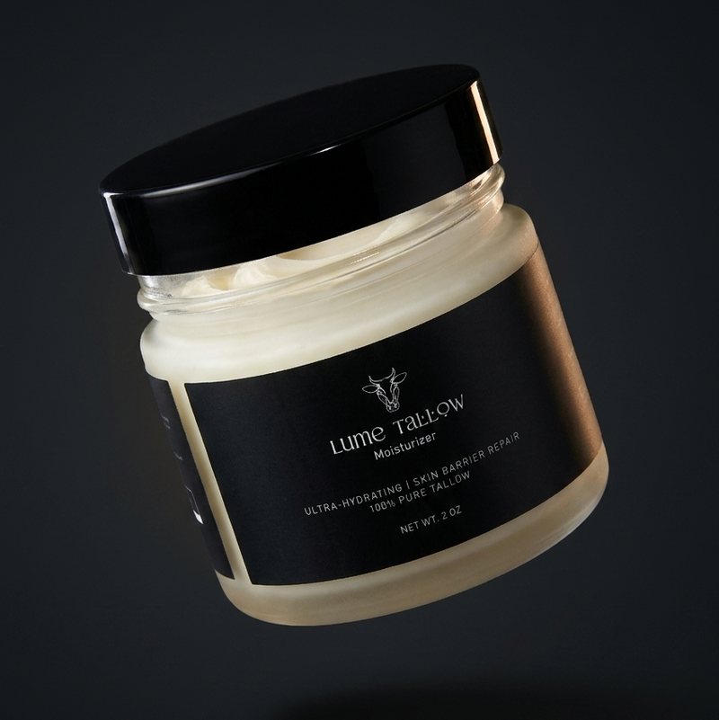 Lume Tallow Recovery Moisturizer jar floating against a moody dark studio background — grass-fed tallow cream that repairs the skin barrier for eczema, dry skin, and post-procedure recovery