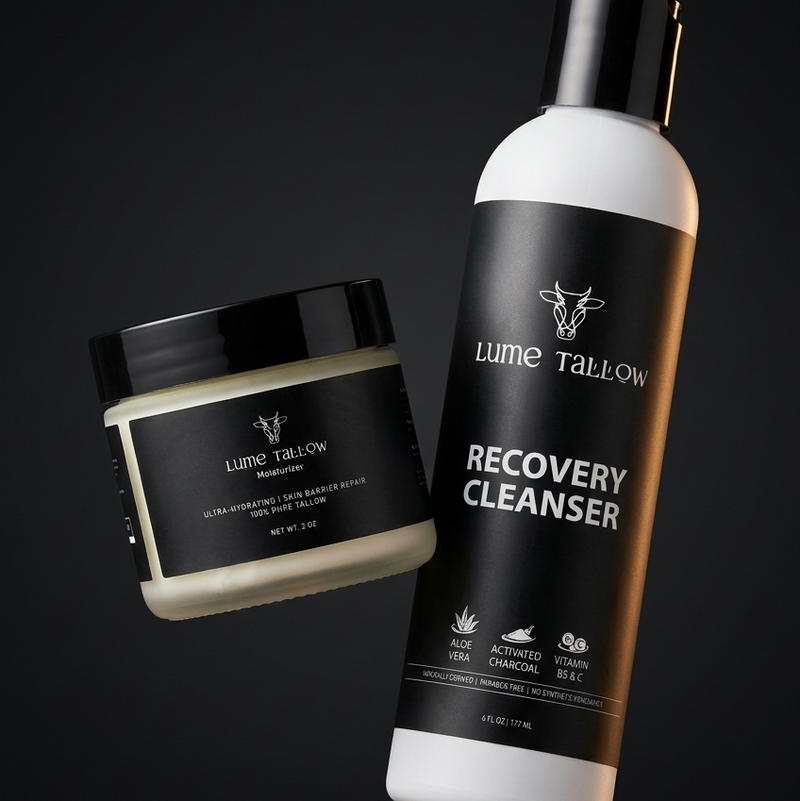 The Lume Tallow Recovery Bundle — Recovery Cleanser and Recovery Moisturizer floating together against a moody dark studio background, a complete post-procedure and barrier-repair skincare system